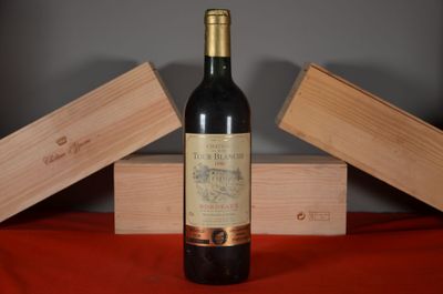 a bottle of wine sitting on a table next to two wooden boxes