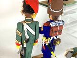 three toy soldiers standing next to each other on display