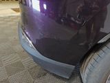 a close up of a purple car with a person taking a picture