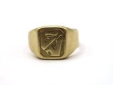 a close up of a gold signet ring on a white background
