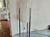 une table en verre sur laquelle se trouvent une lampe et un téléphone