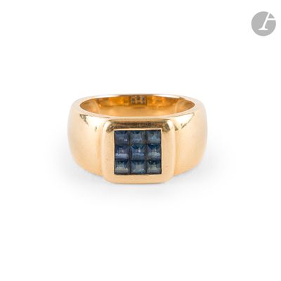 a close up of a gold ring with a blue stone in it