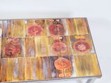 a table that has a glass top with flowers painted on it
