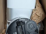 a cardboard box with a toilet and other items in it