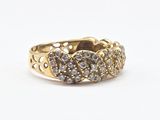a close up of a gold ring with diamonds on a white background