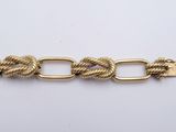 a close up of a gold chain with a clasp on it