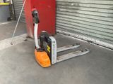 a forklift that is sitting in front of a garage door