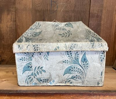 a box that is sitting on a wooden shelf