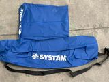 the back of a blue bag with a logo on it sitting on the ground