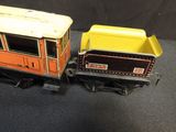 two toy trains sitting side by side on a black surface