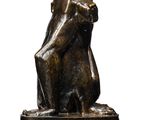 an image of a bronze statue of a monkey on a white background