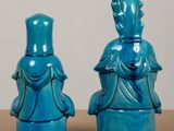 two blue vases that are sitting on a table
