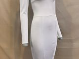 the dress is white and has long sleeves on it