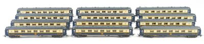six blue and gold train cars are lined up on a white surface