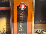 a bottle of whiskey sitting next to a box of wine