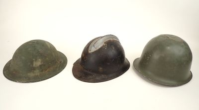 three helmets are lined up in a row on a white surface