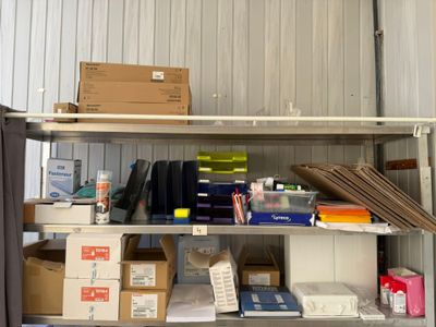 a metal shelf with boxes and other items on it