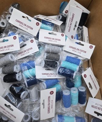 de nombreuses bobines de fil dans une boîte en carton