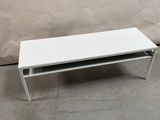 an image of a white coffee table on a concrete floor