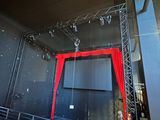 an image of a stage with a red curtain