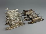 several pieces of silverware sitting on top of a table next to each other