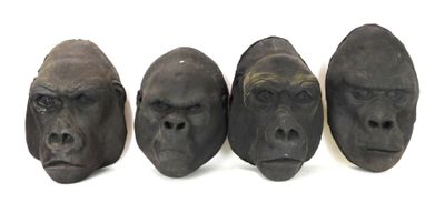 three different sized gorilla heads sitting next to each other on a white surface
