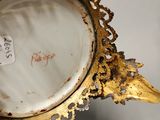 a close up of a gold plate with a bird on it