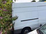 a white van that is parked next to a car