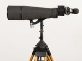 a black telescope on a tripod with a wooden tripod