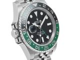 a close up of a wrist watch with a green bezel