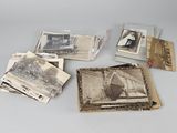 an old photo of a couple of people sitting on top of a table next to a pile of old photos