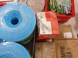 several rolls of blue yarn are sitting on a table next to a box of scissors