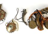 three pieces of jewelry on a white surface with a white background