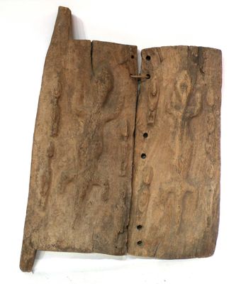 an old piece of wood with holes in it on a white surface