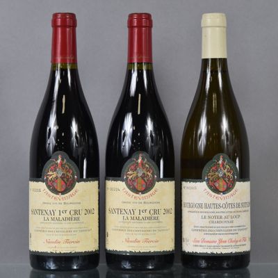 three bottles of wine are lined up on a table