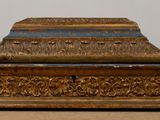 a wooden box with a metal lid on a table