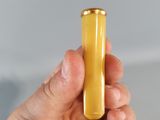a person holding a small yellow object in their hand