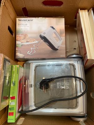 a box that has a microwave in it and some other items in it