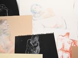 many different colored drawings of people on a table