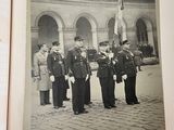 an old photo of a group of men standing in front of a building