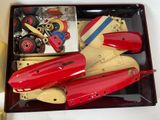 a red toy plane in a box with other toys