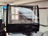 une vitrine en verre contenant des aliments, posée sur une table