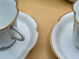 four cups and saucers sitting on a table