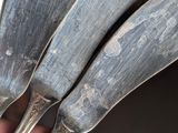 a person holding a set of silverware in their hand