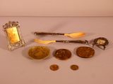 a silver spoon, fork, spoon and spoon rest on a table