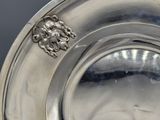 a silver plate with a lion head on it