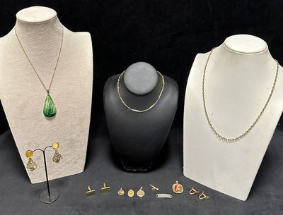 three pieces of jewelry are displayed on display on a black surface