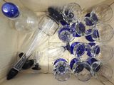 many empty wine glasses and a bottle in a box