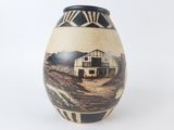 a vase that has a picture of a house on it
