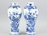pair of blue and white vases with flowers and birds on them